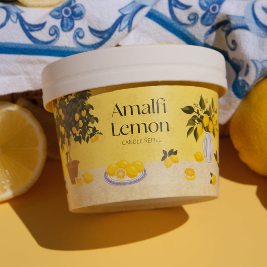 Amalfi Lemon candle refill container with lemons on a yellow background